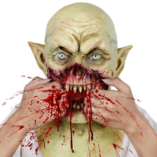 Masque Halloween de vampire à la peau verte et aux oreilles pointues mordant des mains ensanglantées