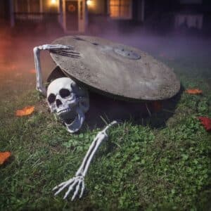 Photo d'une mise en scène avec un squelette de décoration pour Halloween dans un jardin